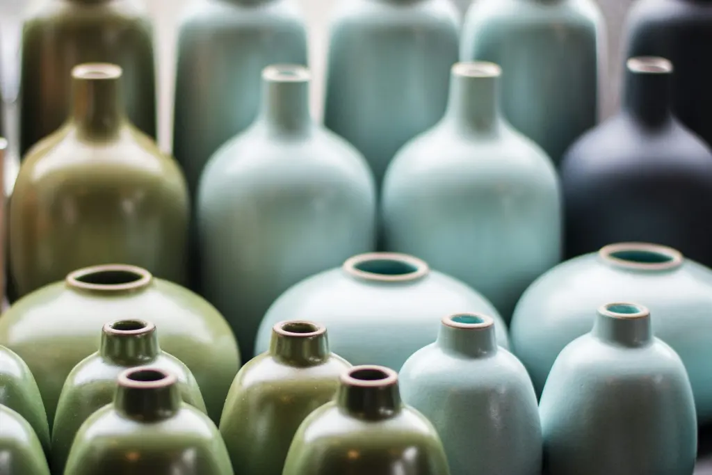 Stoneware cups with a glossy glaze inside and bare clay outside